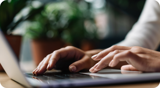 student accounts tablet, headphones, coffee, and keyboard on a desk
