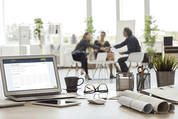 laptop showing the Fullscript platform with three people in the background chatting