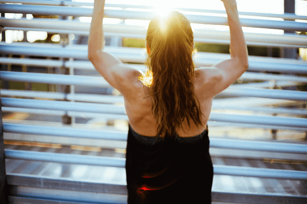 woman working out, focus on shoulder and arm muscles