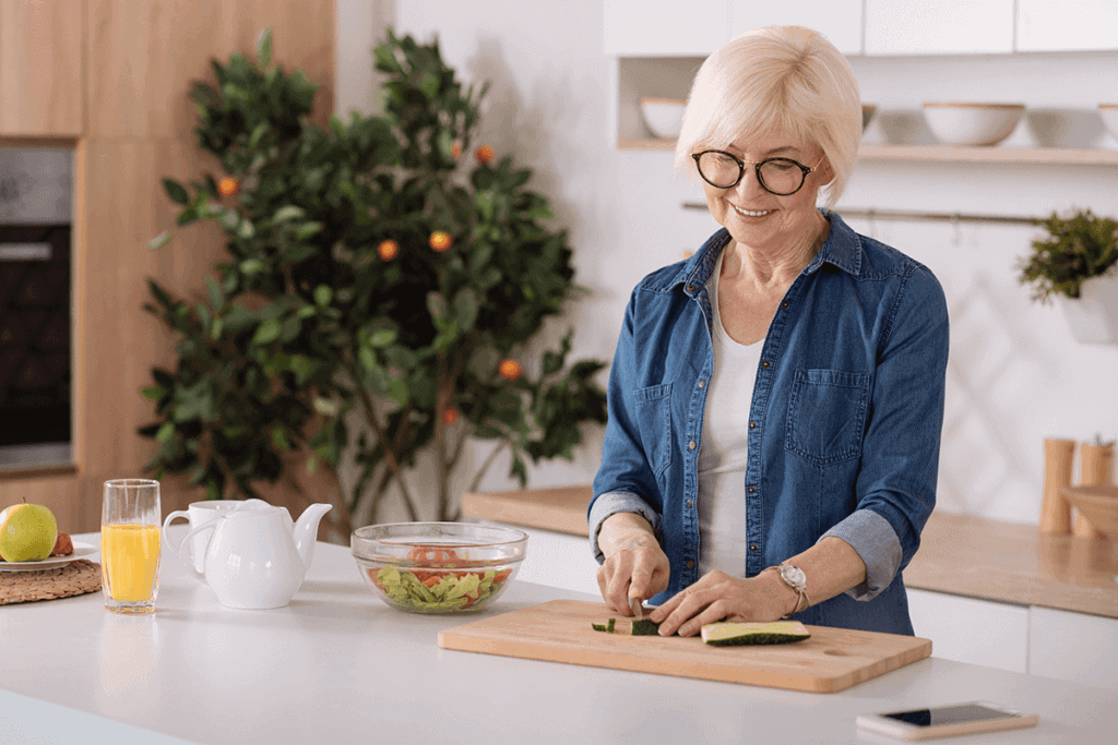 woman cutting vegetables in kitchen