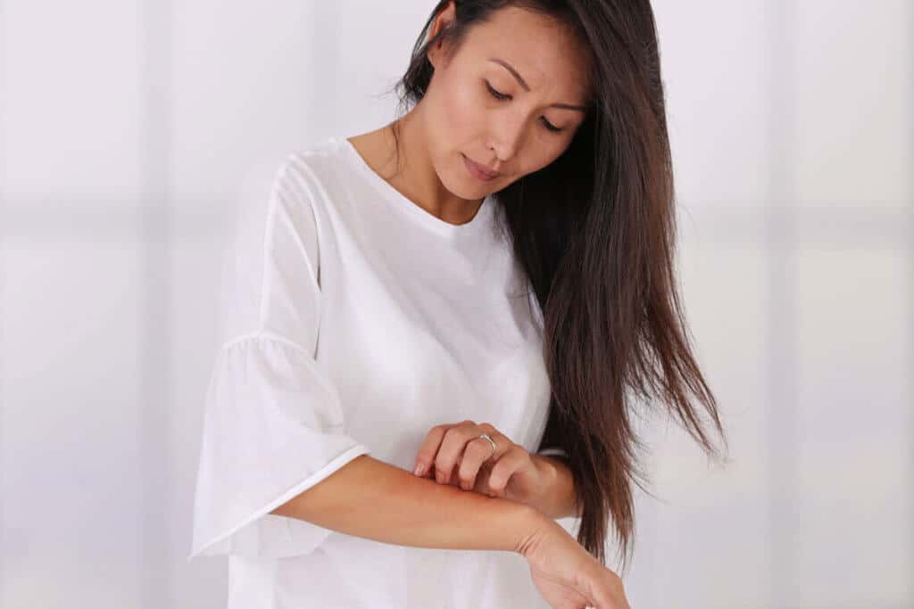 woman looking at her arm