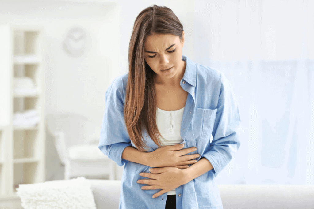 woman holding her stomach in pain