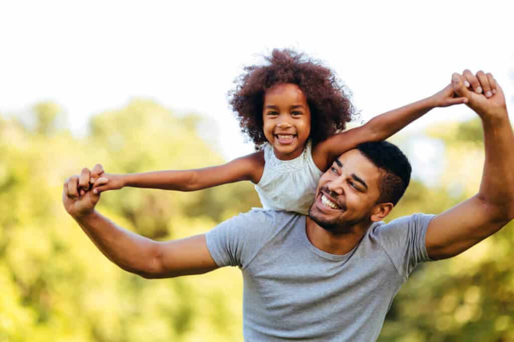daughter on father's back