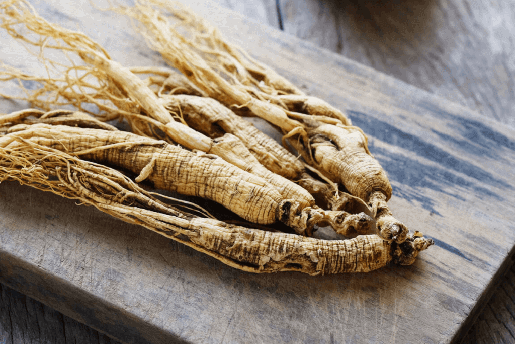 Ginseng root placed on a wooden background.
