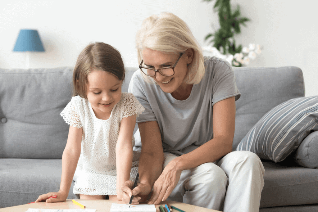 older woman with younger child, reading in living room