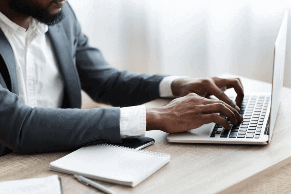 person typing on their laptop