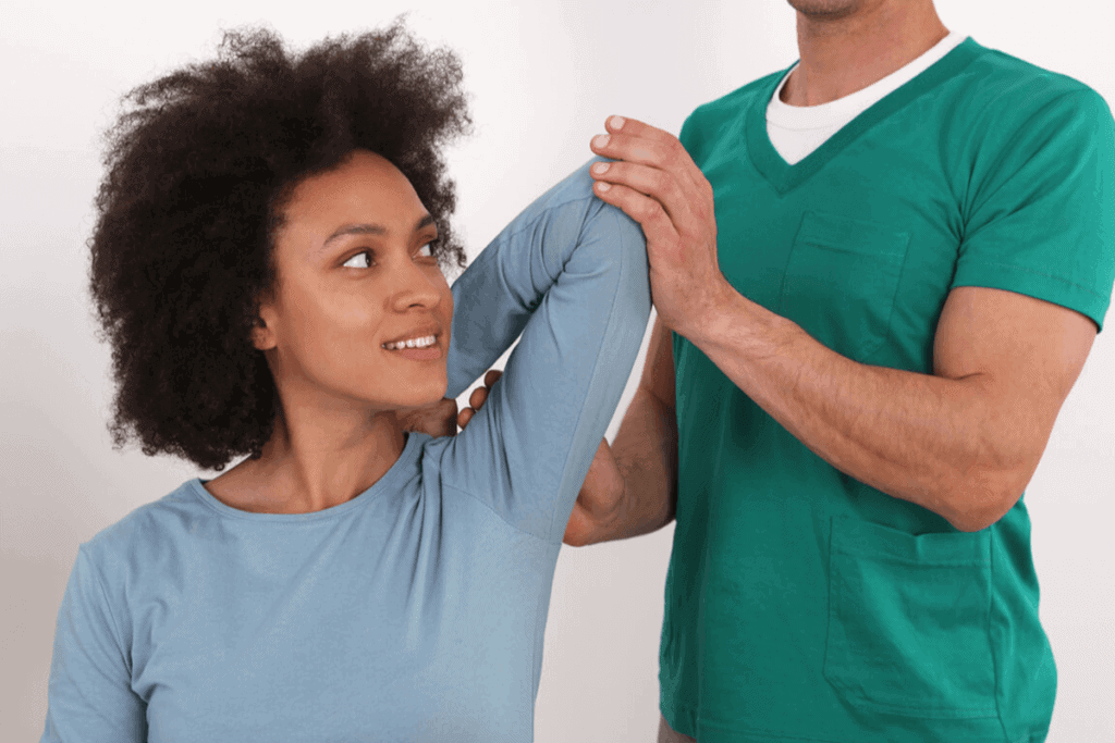 Physiotherapist helping a patient stretch their arm