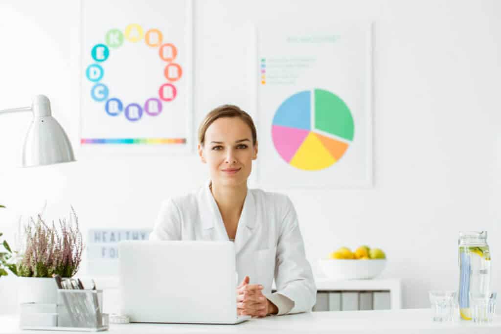 practitioner in office sitting in front of computer