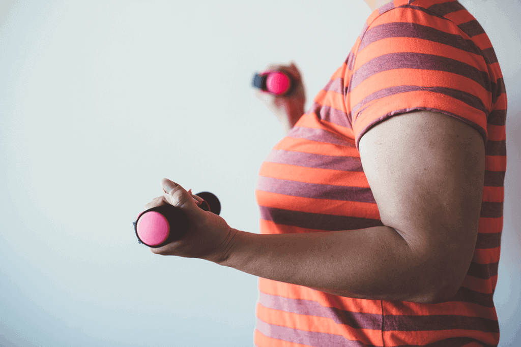 woman exercising with weights in her hands