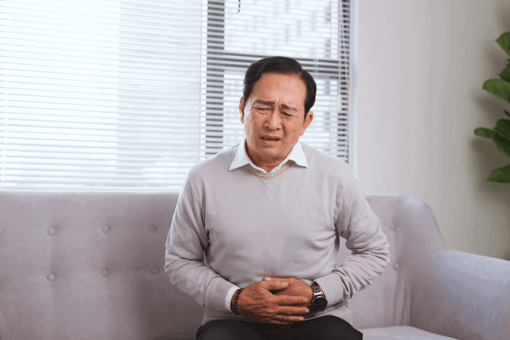 man holding his stomach in pain