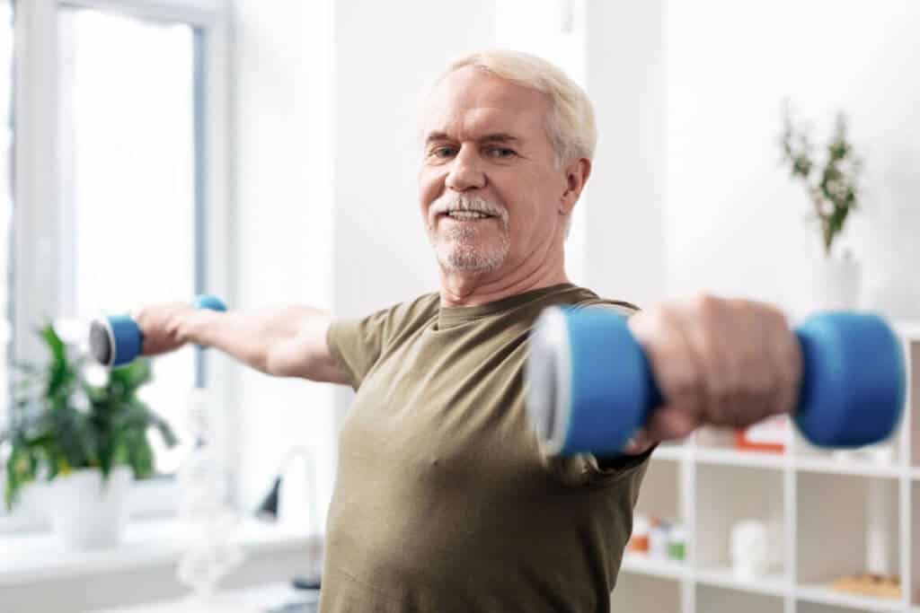 elder man lighting weights in each hand