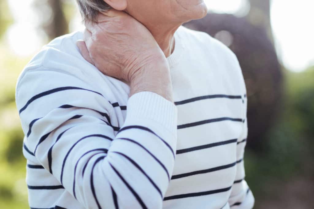 Image of woman holding neck