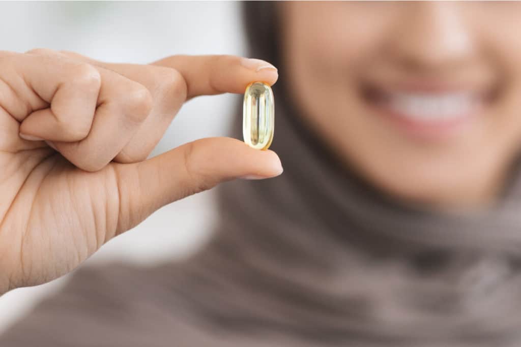 Woman holding a vitamin