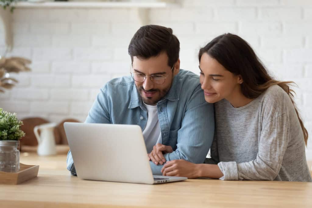 Man and woman looking at a laptop screen