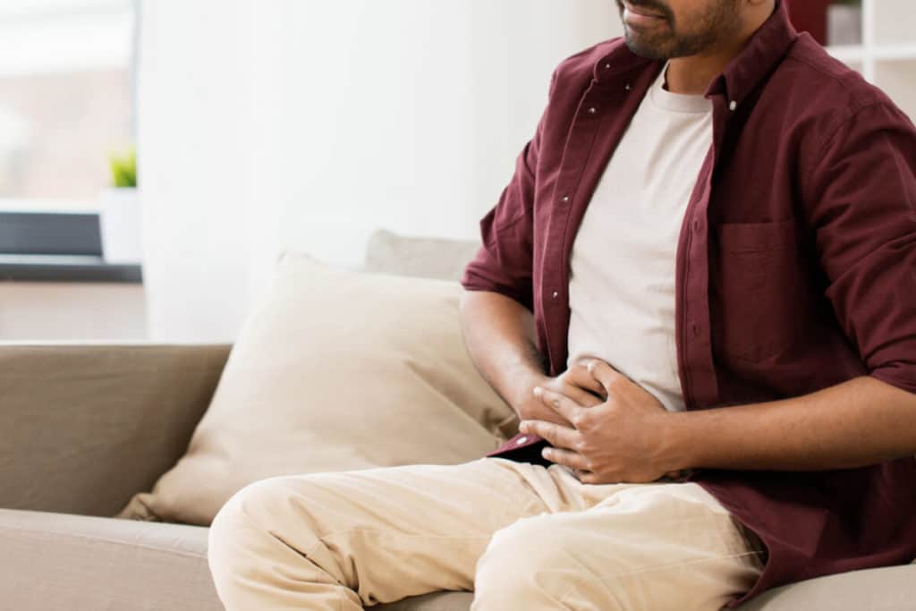 Man holding abdominal area