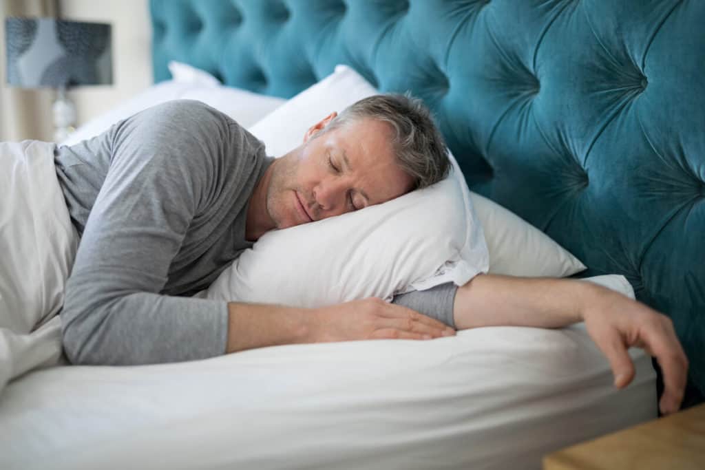 man sleeping in bed